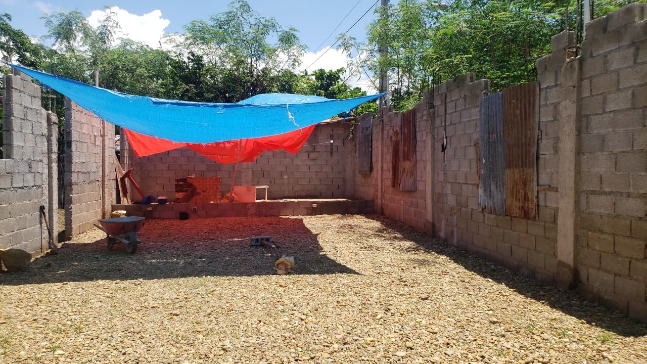 A red and blue tarp hanging over the ground.