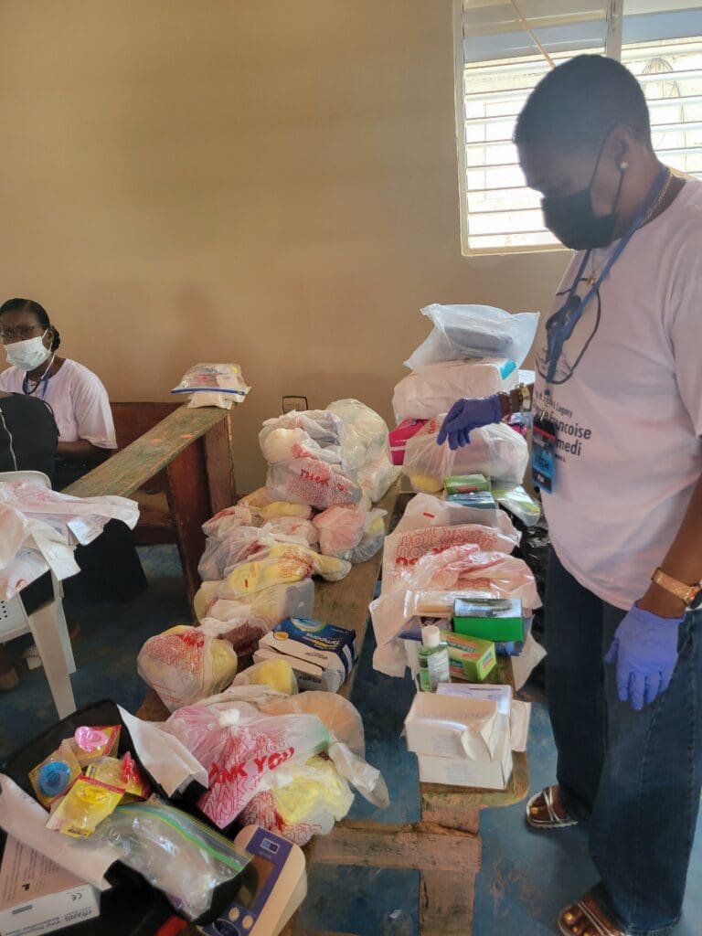 A man standing in front of many bags of food.