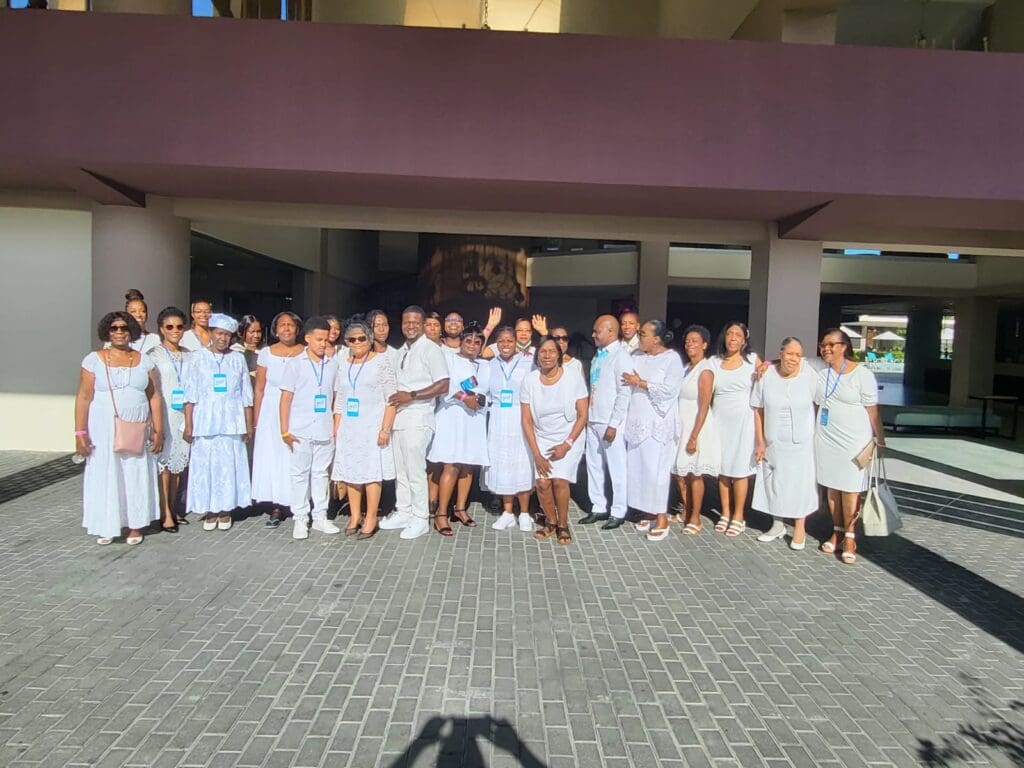 A group of people in white uniforms standing outside.