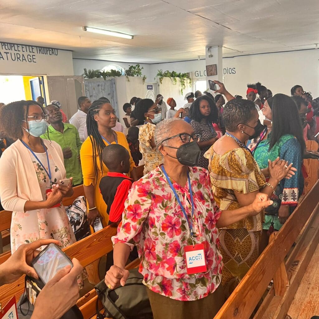 A group of people in church with masks on.