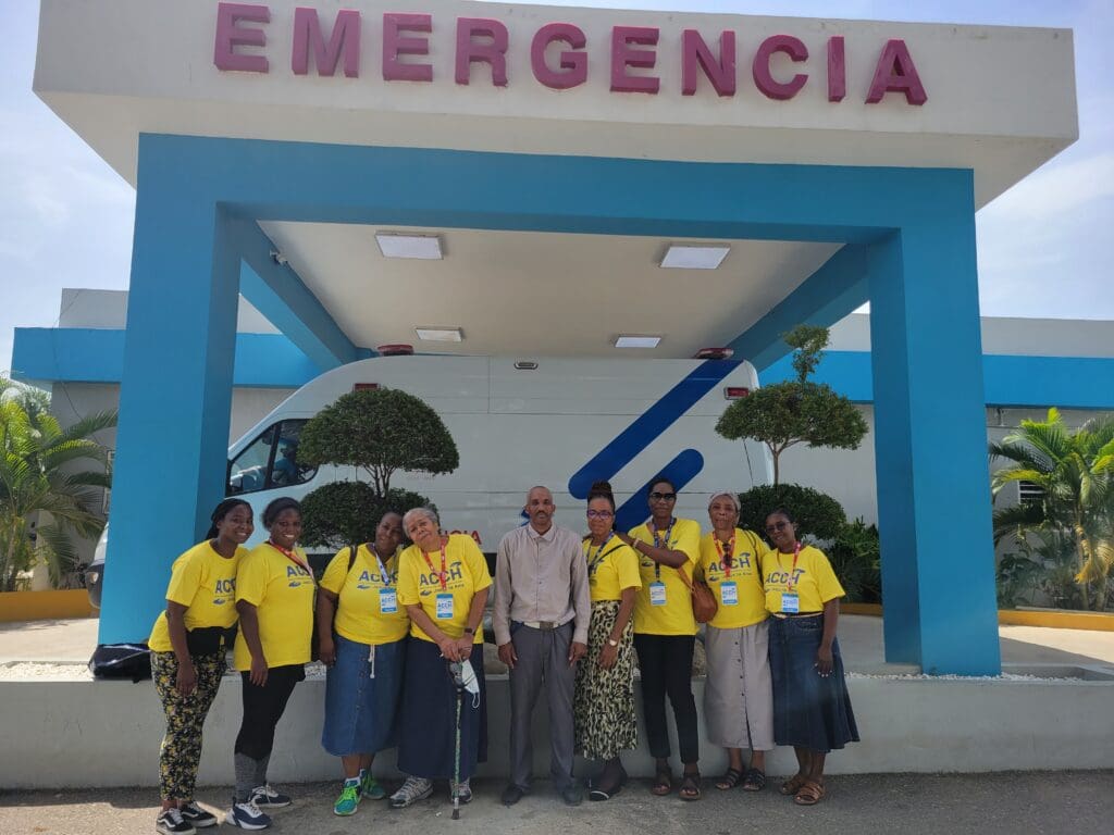 A group of people standing in front of an emergency room.