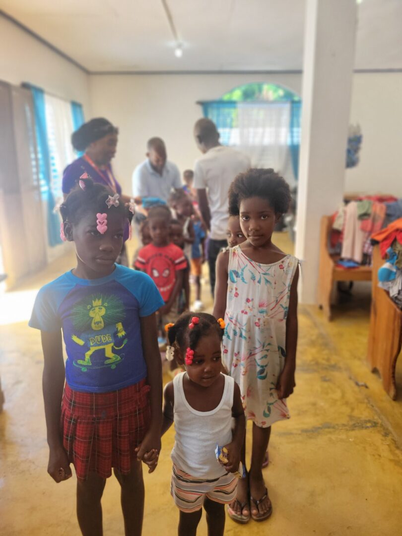 A group of children standing in a room.