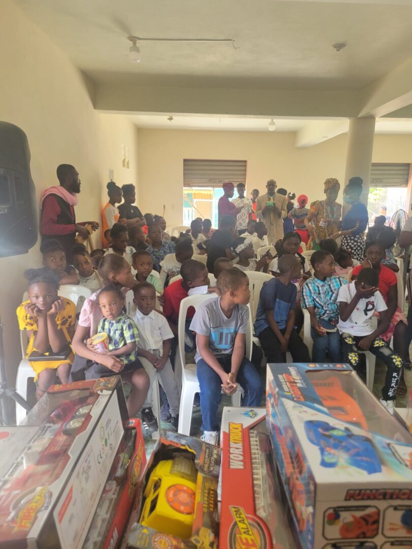 A group of people standing around boxes filled with toys.