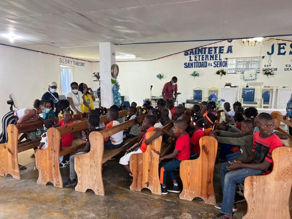 A group of people sitting in chairs at a church.